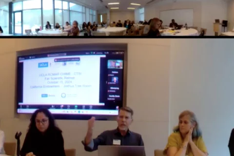 Group of five panelists giving presentation in front of a screen.